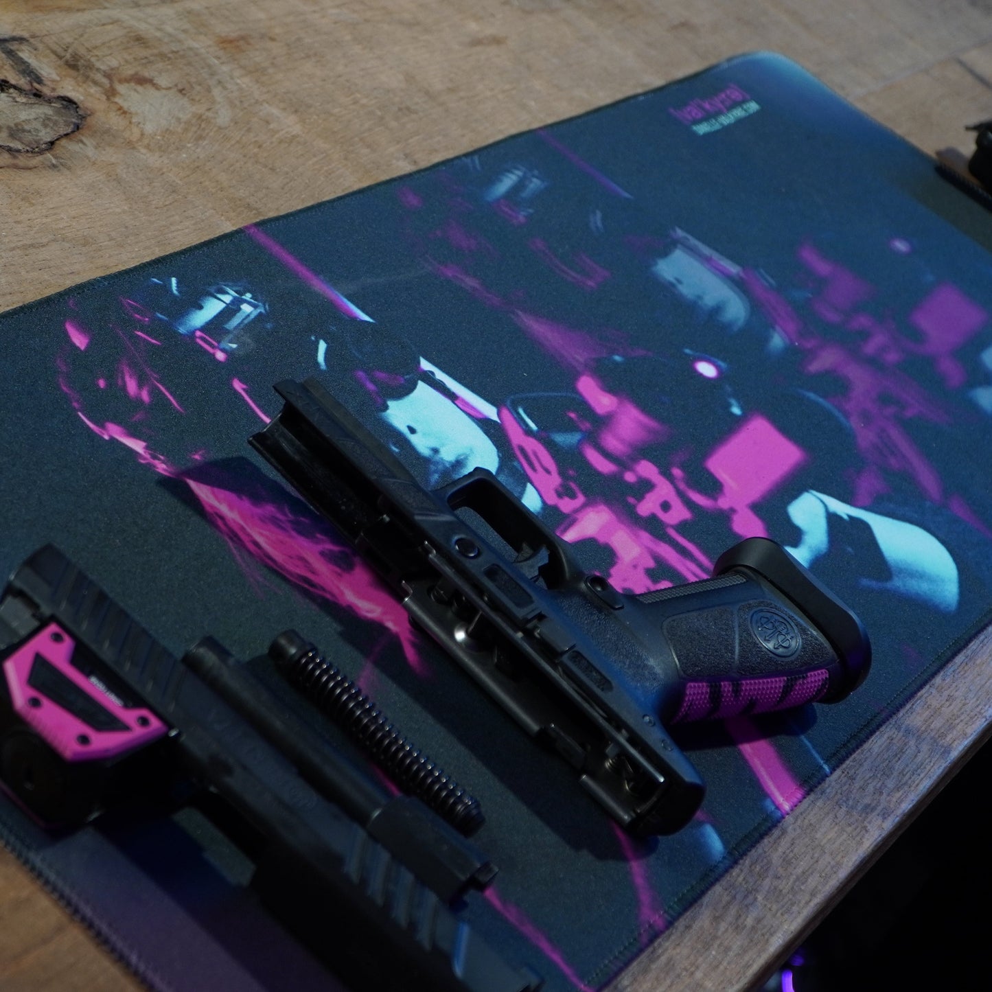 Gaming mouse pad with colorful design on a wooden surface