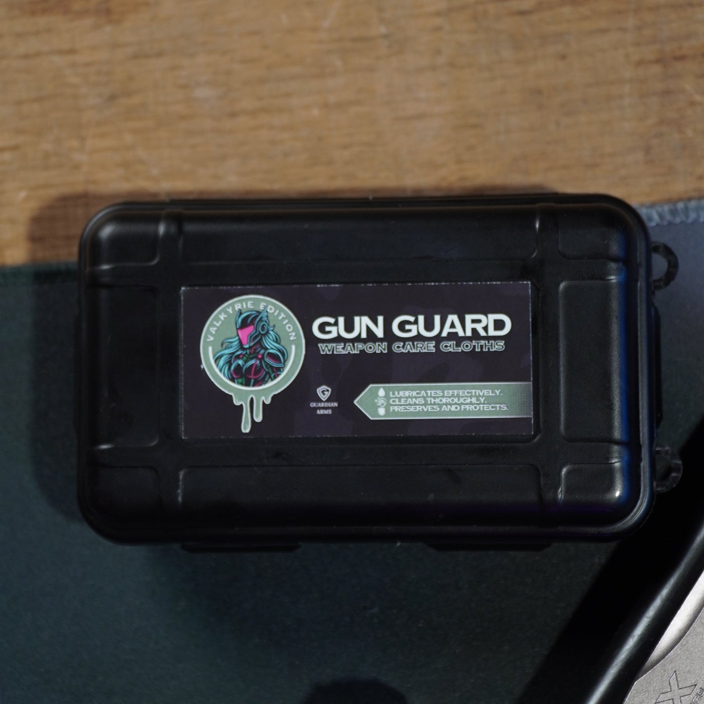 Black gun case with 'Gun Guard' branding on a wooden surface
