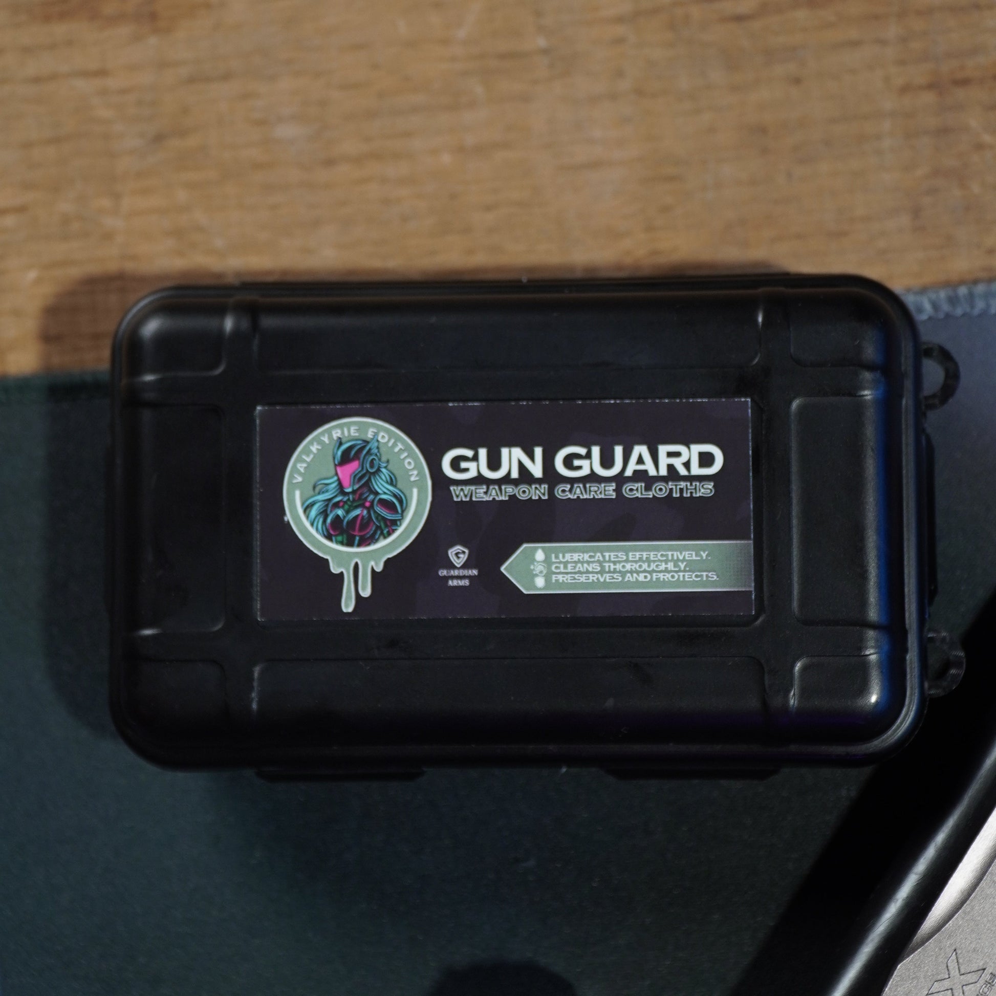 Black gun case with 'Gun Guard' branding on a wooden surface